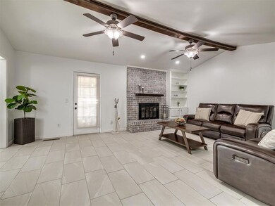 Living room featuring ceiling fan, vaulted ceiling