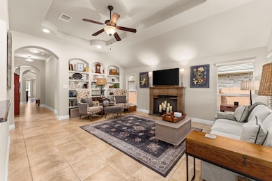 Living room with visible vents, built in shelves,