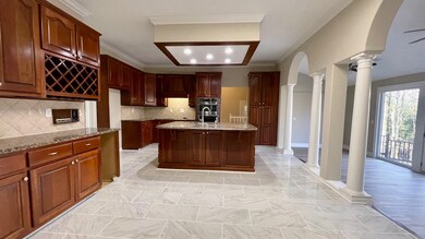 Kitchen featuring double oven, light stone counter