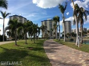 Paver drive  in and out lined with big Palms