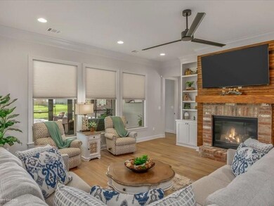 Living room featuring crown molding, a fireplace, 