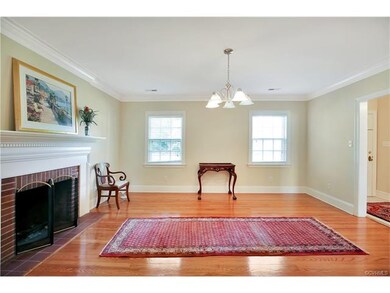 Living room with wood burning fireplace, refinished hardwood, 3 pc crown molding.