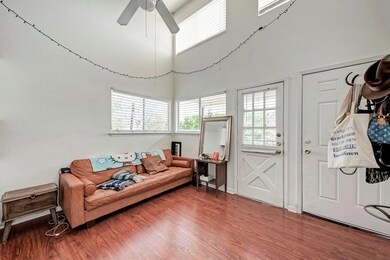 Living room with a ceiling fan, wood finished flo