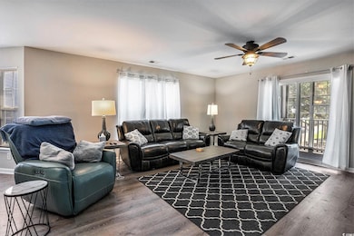 Living area featuring a ceiling fan and wood finished floors