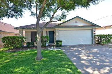 Ranch-style home featuring brick siding, concrete driveway, a front lawn, and an attached garage