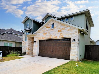 Contemporary house featuring stone siding, an att