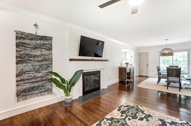 living room view into dining and kitchen