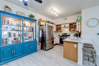 Kitchen with a peninsula, light countertops, backs
