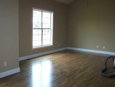 Large den with hardwood floors.