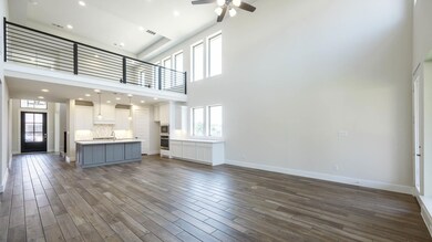 Unfurnished living room with ceiling fan, dark wo