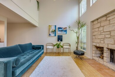 Living room featuring a stone fireplace, a toweri