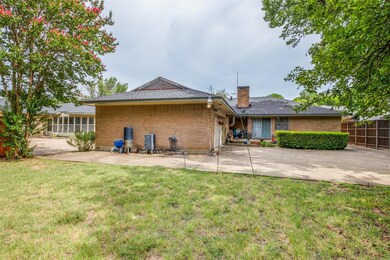 Rear view of house featuring a patio and a yard