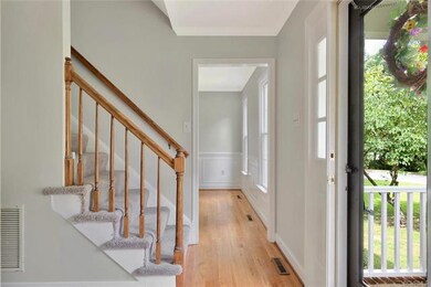 Foyer with fresh paint, newly refinished wood floo