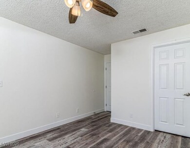 Unfurnished bedroom with visible vents, ceiling fa