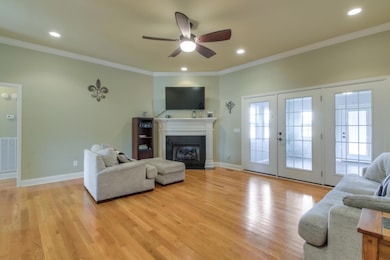 Large living room with hardwood floors and gas fireplace.