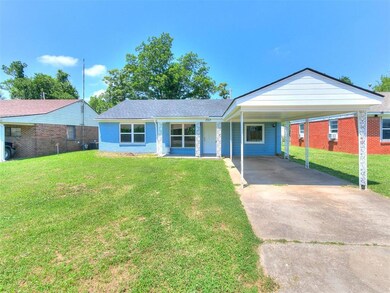 Ranch-style home featuring a front yard and a carport