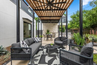 View of patio with a ceiling fan, an outdoor hang