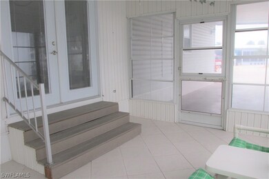 Front lanai toward carport w/stairs into house.