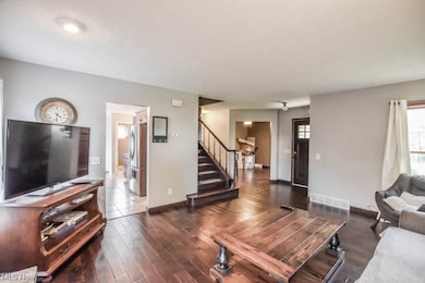 Living room with dark wood-type flooring
