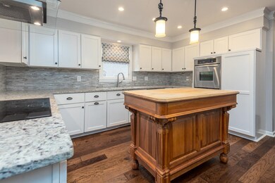 Kitchen with ornamental molding, oven, black elect