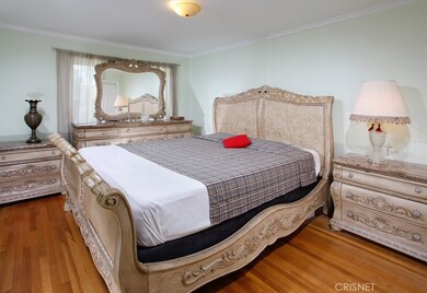 The bright and spacious master bedroom and guest bedrooms are enriched by picture windows, crown molding, 2 with lighted ceiling fans, ample closet space with paneled wardrobe doors and lustrous hardwood floors.