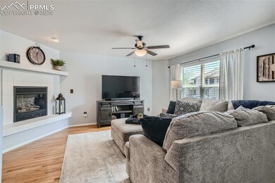 The living room features natural lighting, a firep