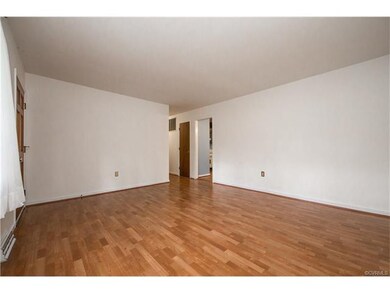 View of living room and entrances to hallway and k