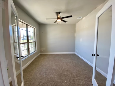 Bright study with modern glass double doors and ceiling fan