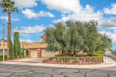 View of front of property featuring a garage, driveway, stucco siding, and a tiled roof