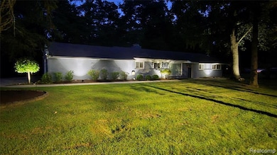 Ranch-style home with a yard and brick siding