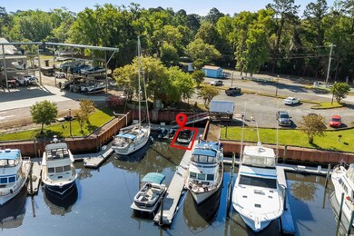 View of dock with a water view and a wooded view