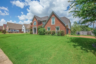 View of front of house with brick siding and a shingled roof