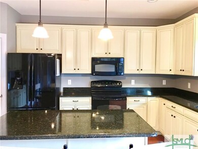 Miles of great cabinetry, granite counters, and desired center island creates your dream kitchen