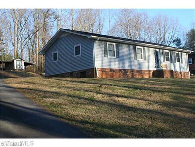 Exterior Front. Side view of house with paved drive leading to carport.  Nice paved circle driveway!