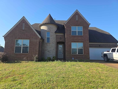 View of front of home with concrete driveway, bric