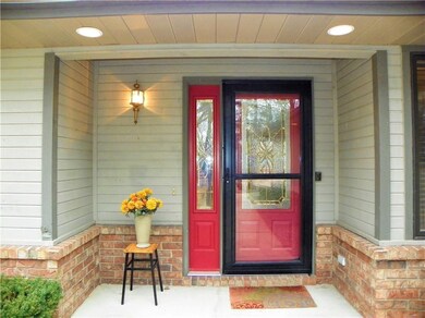 A welcoming, covered front porch! Beautiful leaded glass panels & a solid Larsen storm door.