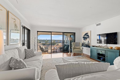 Living area featuring crown molding and wood finished floors