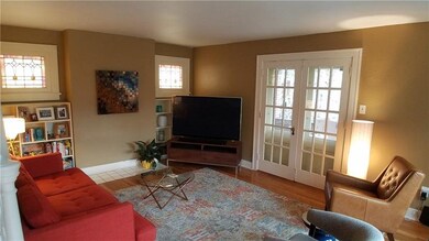 Living room features stained glass windows, built 