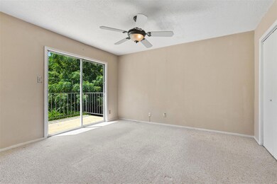 The vast master bedroom is a tranquil space with a sliding glass door that opens to a private balcony
