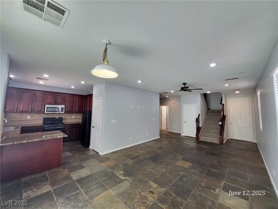Living area featuring stairway, a ceiling fan, dar