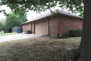 View of home's exterior with a garage and central 