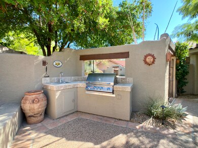 BBQ island with sink and bar area