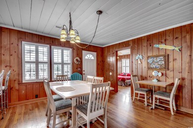 Dining room featuring a notable chandelier, wood w