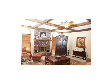 Beautiful Family Room with box beam ceiling, brick