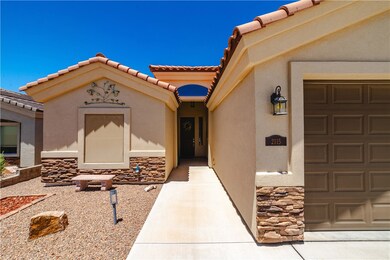 Doorway to property with a garage, stucco siding,