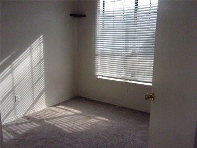 Empty room with dark colored carpet
