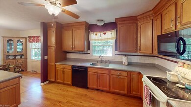 Kitchen with backsplash, brown cabinets, light cou