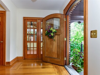 Entry with doors that open to the home's four seas