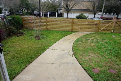 Nice size Front yard behind wooden fence + gate.