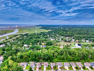 Aerial view of property's location featuring a large body of water and nearby suburban area